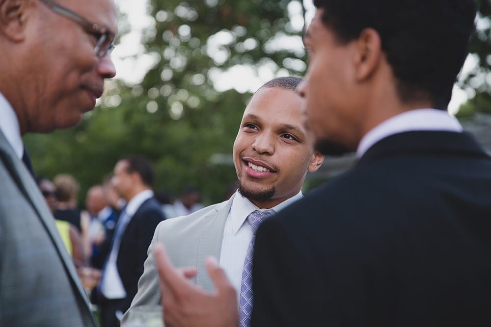 A documentary photograph of guests talking and laughing during the cocktail hour of a Martha's Vineyard Wedding