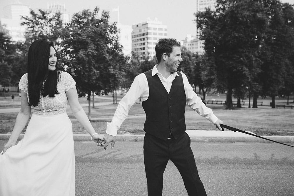 A documentary photograph of couple walking their dog in Boston Common during their Boston Engagement Session