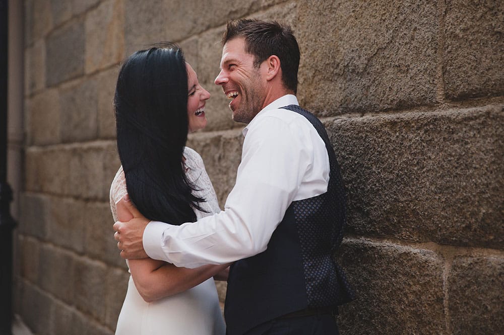 A documentary photograph of a couple laughing during their Boston Engagement Session