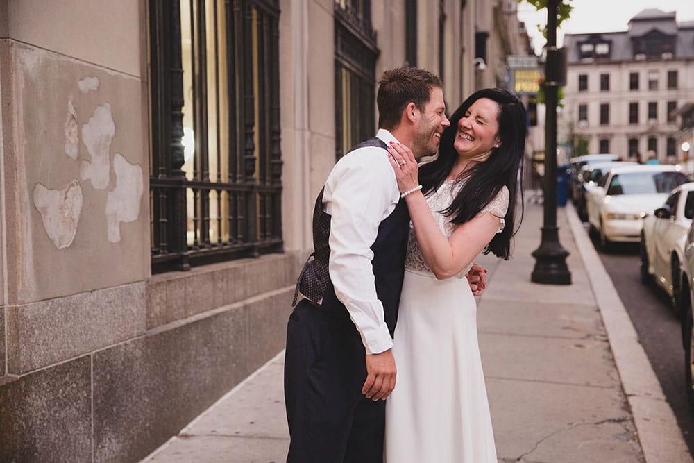 A documentary photograph of couple laughing during their Boston Engagement Session 