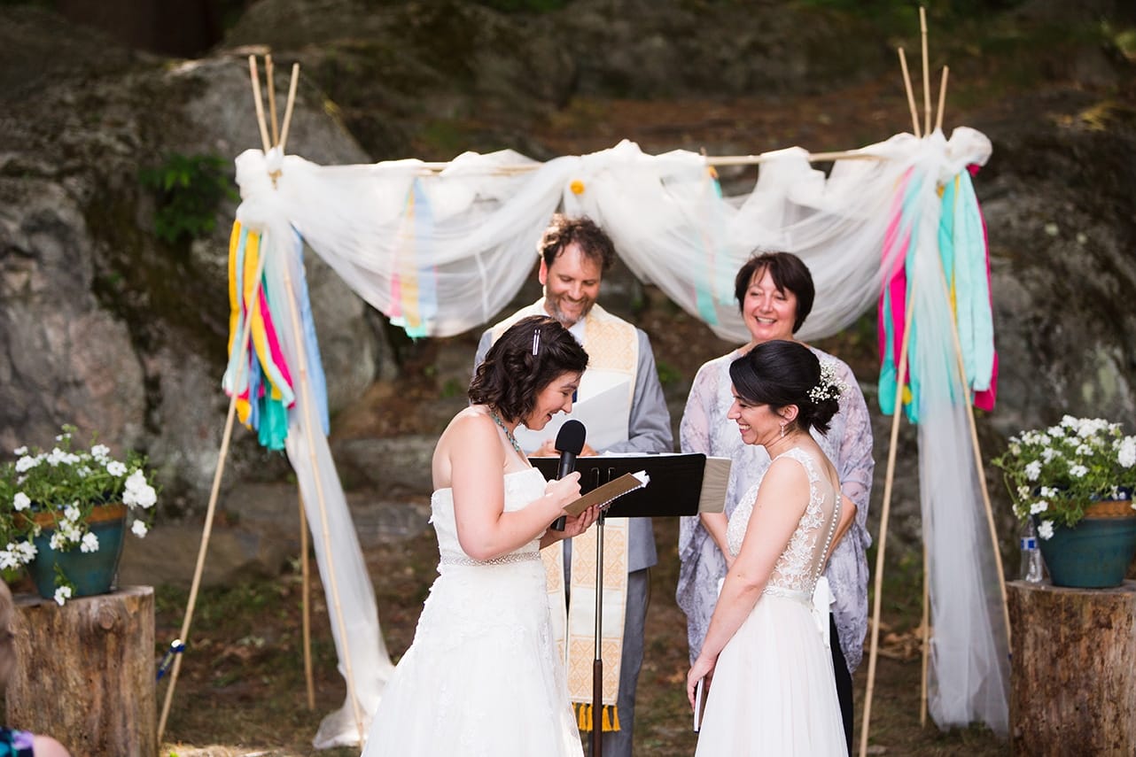 A documentary photograph of a bride reading her vows during their outdoor ceremony at Friendly Crossways Wedding venue