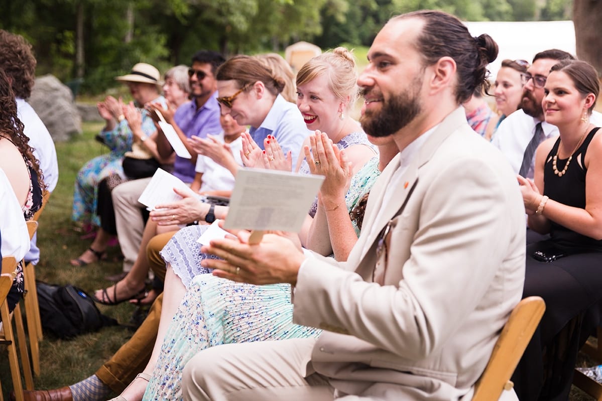 A documentary photograph of guest clapping during an intimate wedding ceremony at Friendly Crossways
