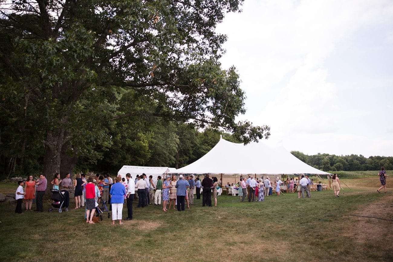 A documentary photograph of guests enjoying cocktail hour at a Friendly Crossways Wedding