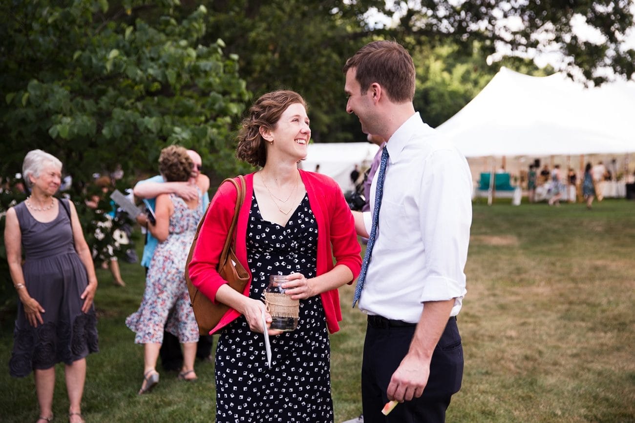 A documentary photograph of guest talking during cocktail hour at a Friendly Crossways Wedding