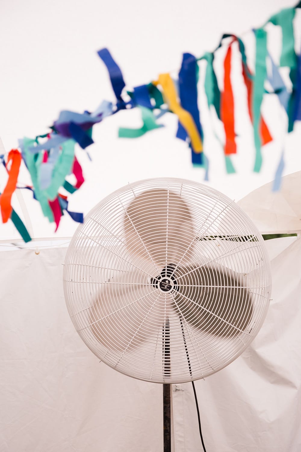 A documentary photograph of a fan blowing wedding decorations at a Friendly Crossways Wedding