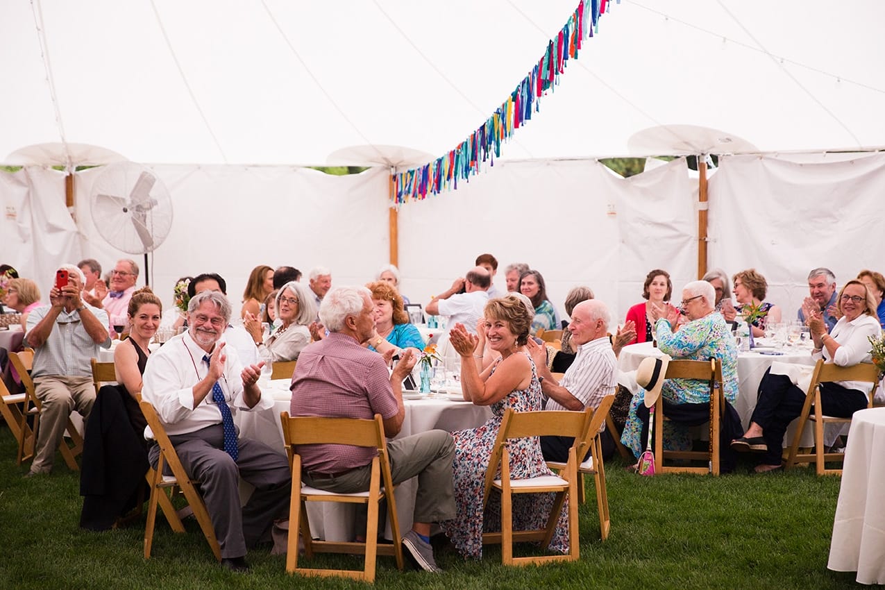 A documentary photograph of guests clapping during a Friendly Crossways Wedding
