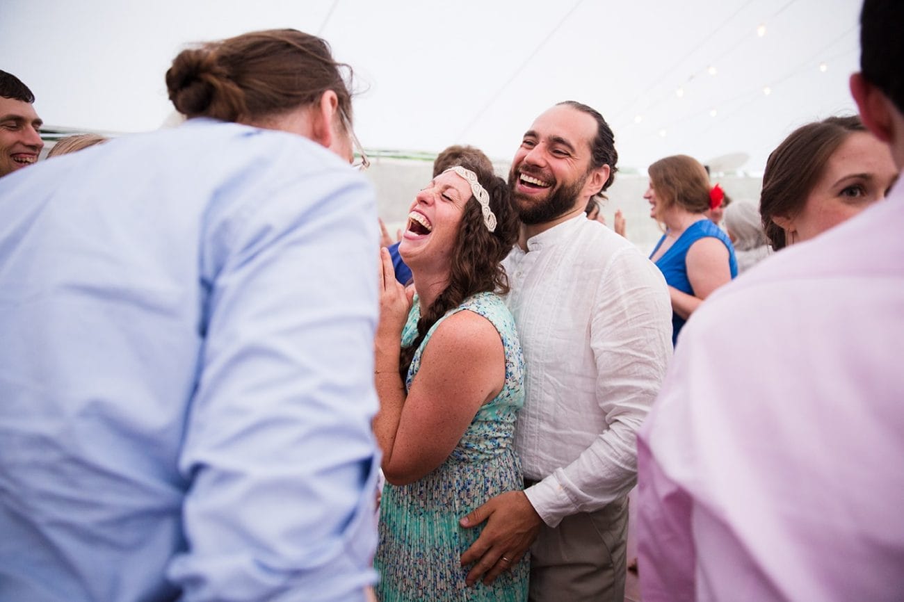 A documentary photograph of guests laughing and dancing during a Friendly Crossways Wedding