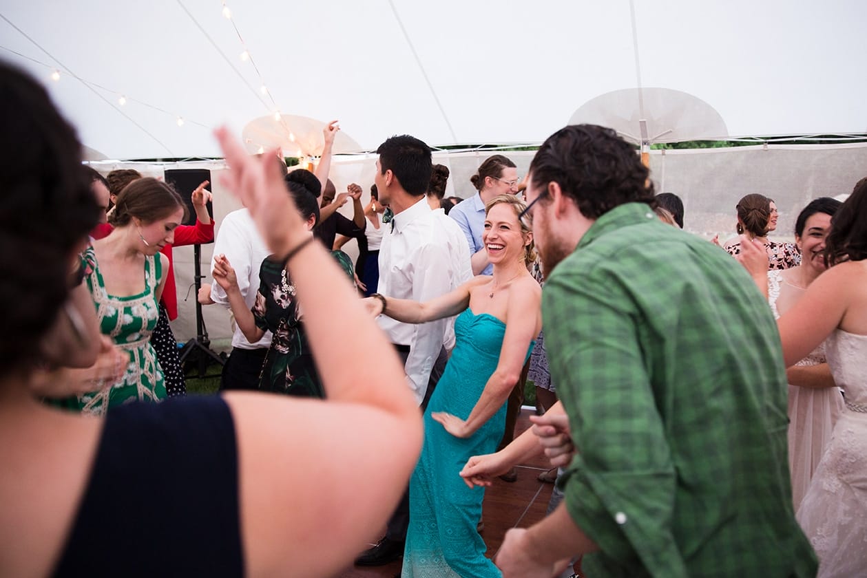 A documentary photograph of guests dancing at a Friendly Crossways Wedding