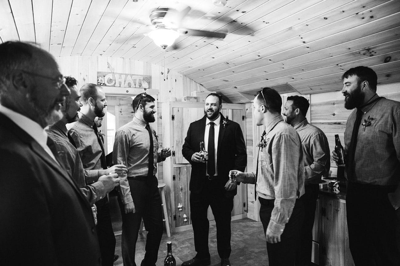 A documentary photograph of a groom with his groomsmen before his Kingsley Pines Camp Wedding in Maine