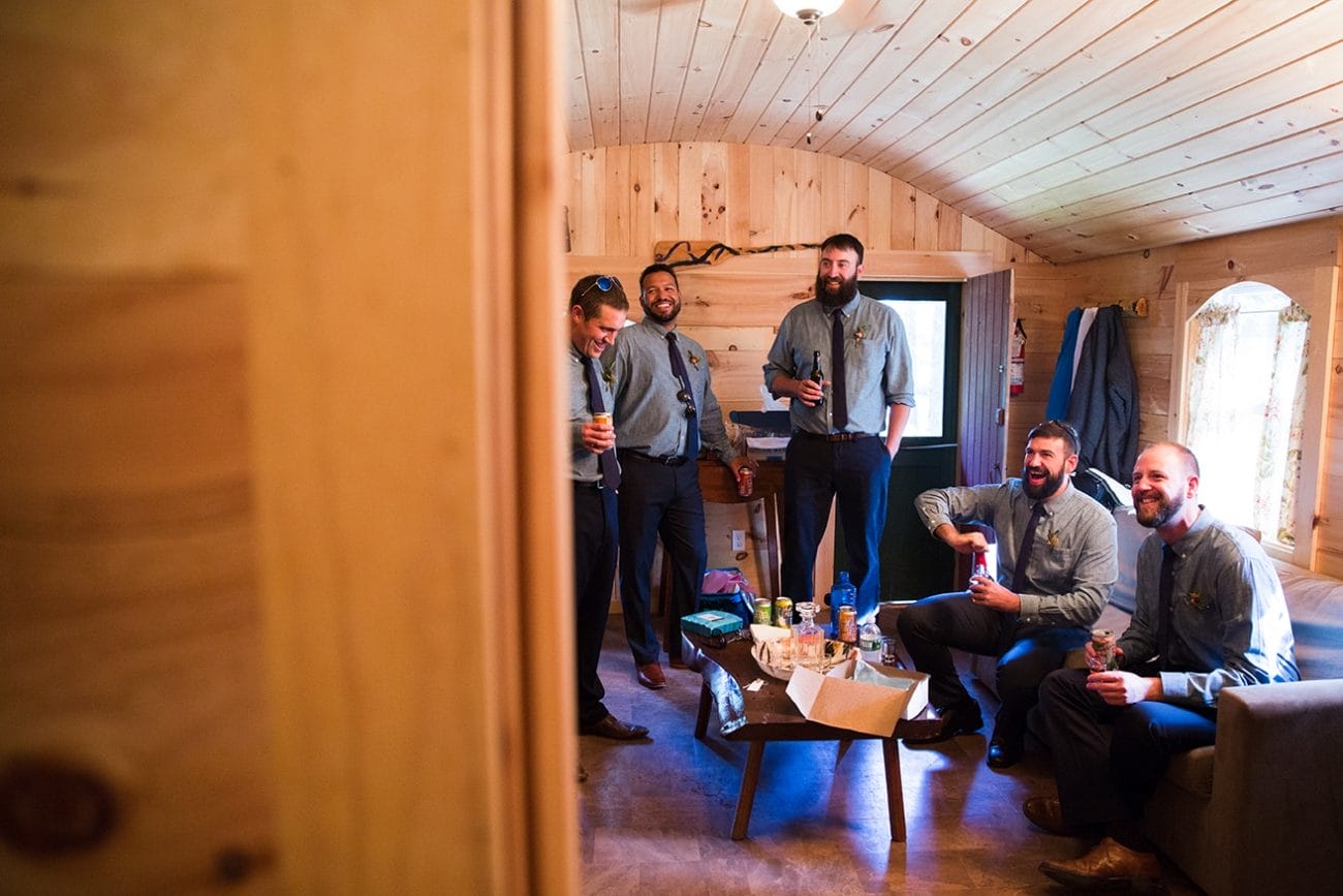A documentary photograph of groomsmen getting ready before a Kingsley Pines Camp Wedding in Maine