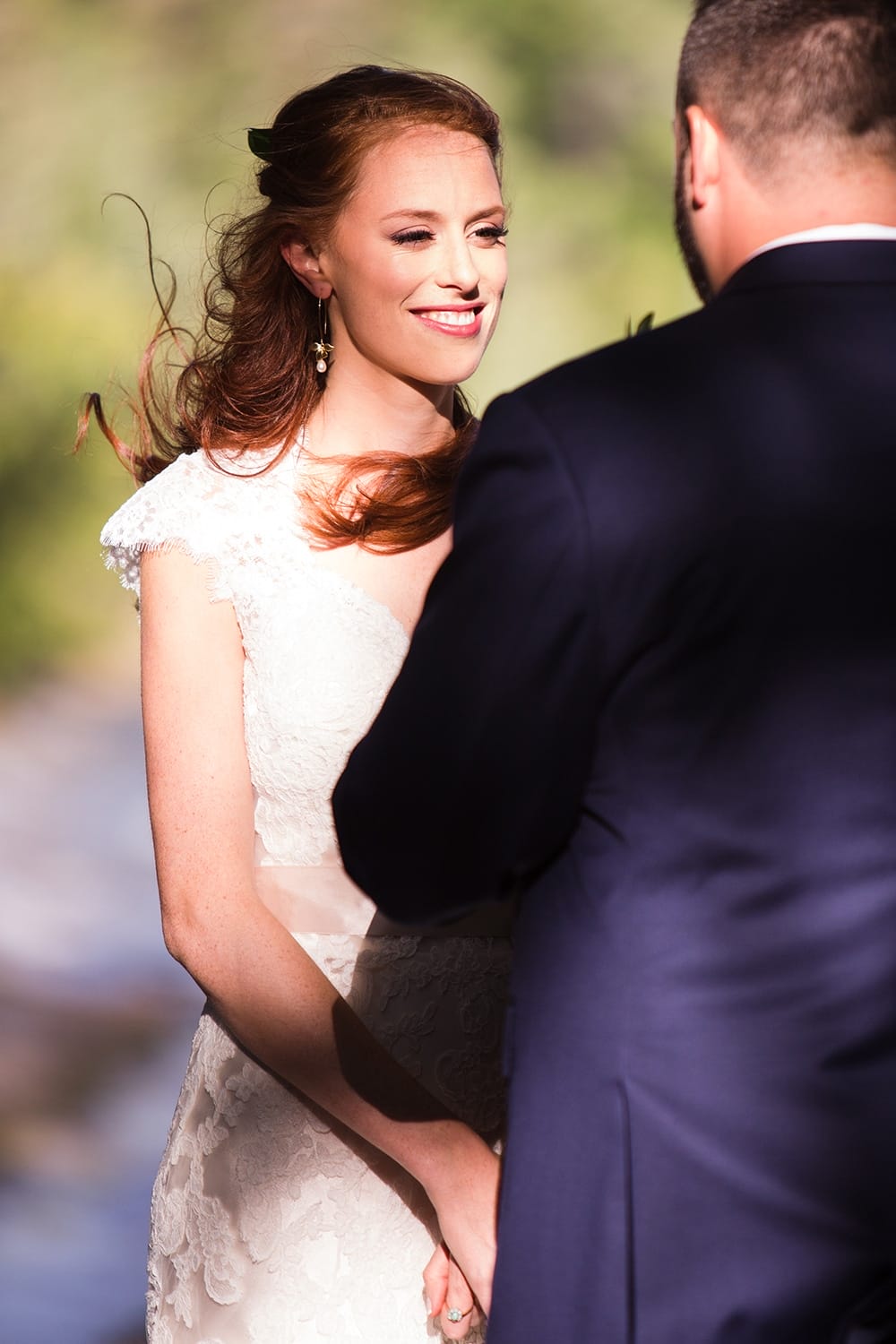 A documentary photograph of bride during her outdoor wedding ceremony at Kingsley Pines Camp in Maine