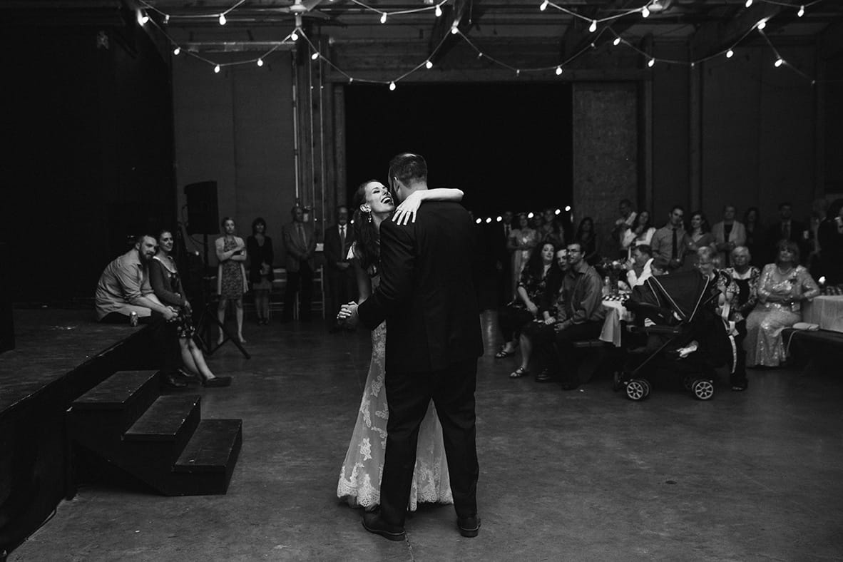 A documentary photograph of a bride and groom having their first dance at their Kingsley Pines Camp Wedding in Maine
