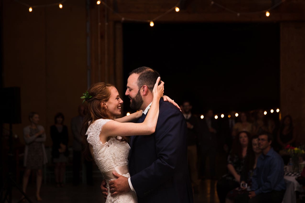 A documentary photograph of a bride and groom dancing during their Kingsley Pines Camp Wedding in Maine