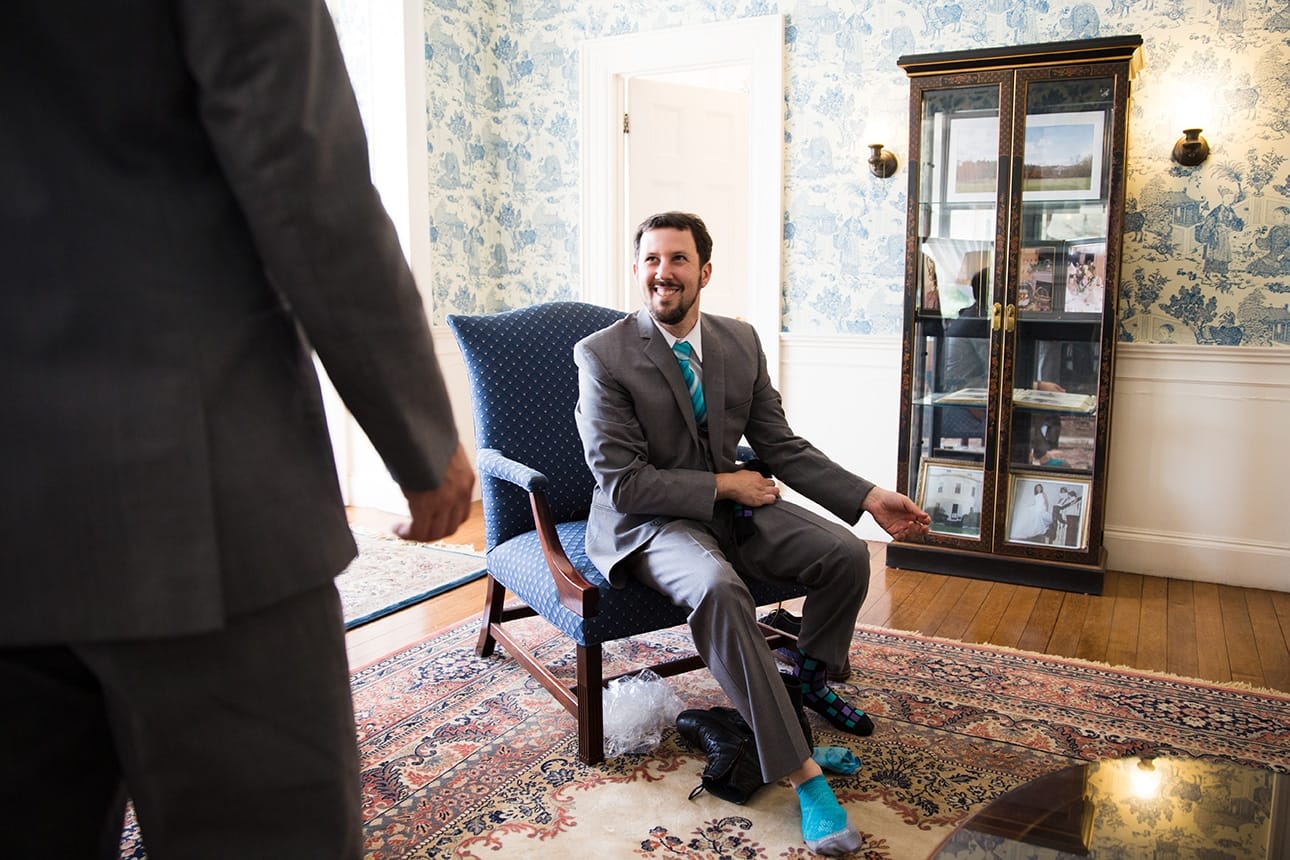 A documentary photograph of a groom getting ready before his Lyman Estate Wedding in Boston, Massachusetts