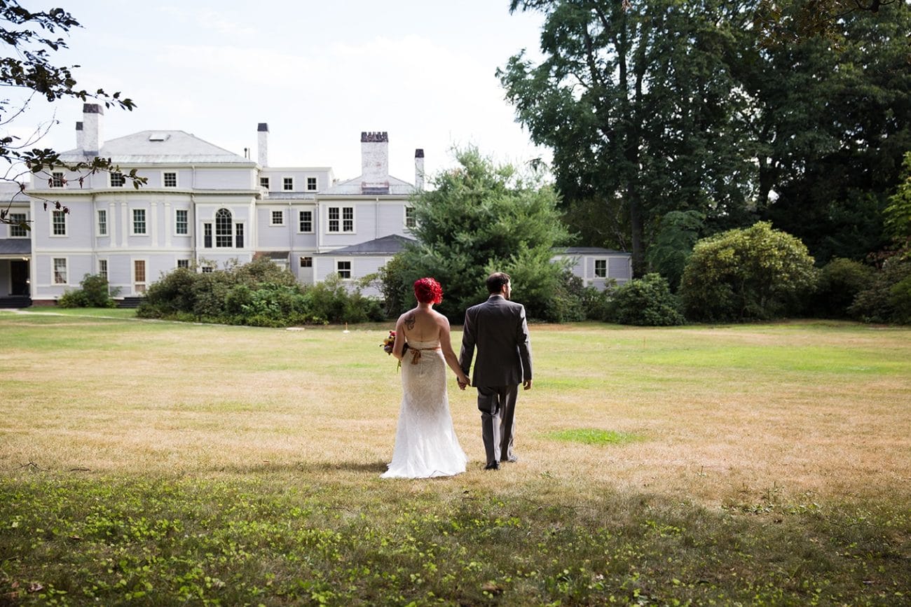 A documentary photograph of a couple walking together during their Lyman Estate Wedding in Boston, Massachusetts