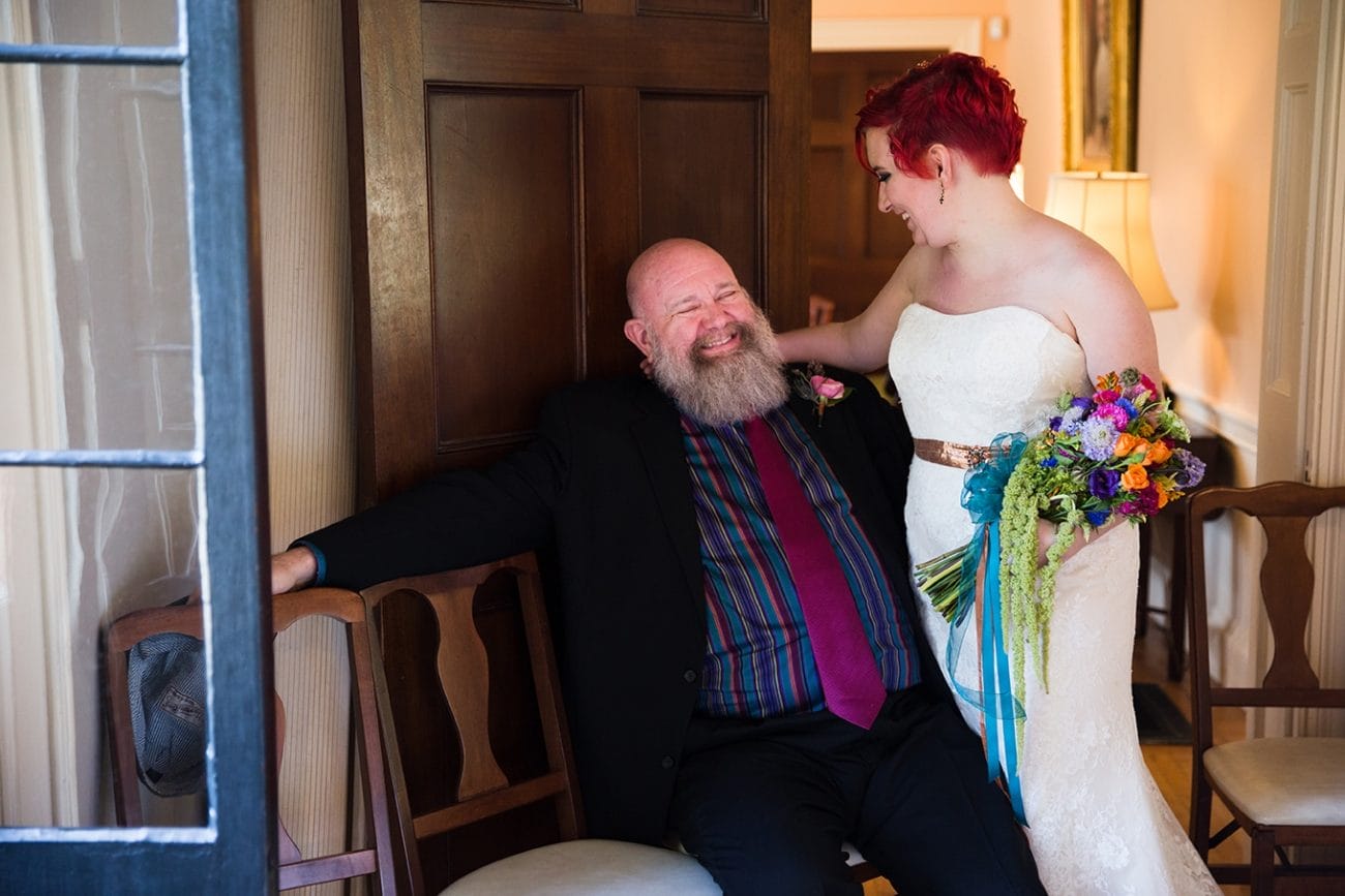 A documentary photograph of a bride laughing with her father before they walk down of the aisle during a Lyman Estate Wedding in Boston, Massachusetts