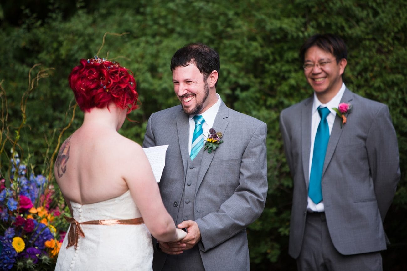 A documentary photograph of a groom smiling with his bride at the top of the aisle during their Lyman Estate Wedding in Boston, Massachusetts