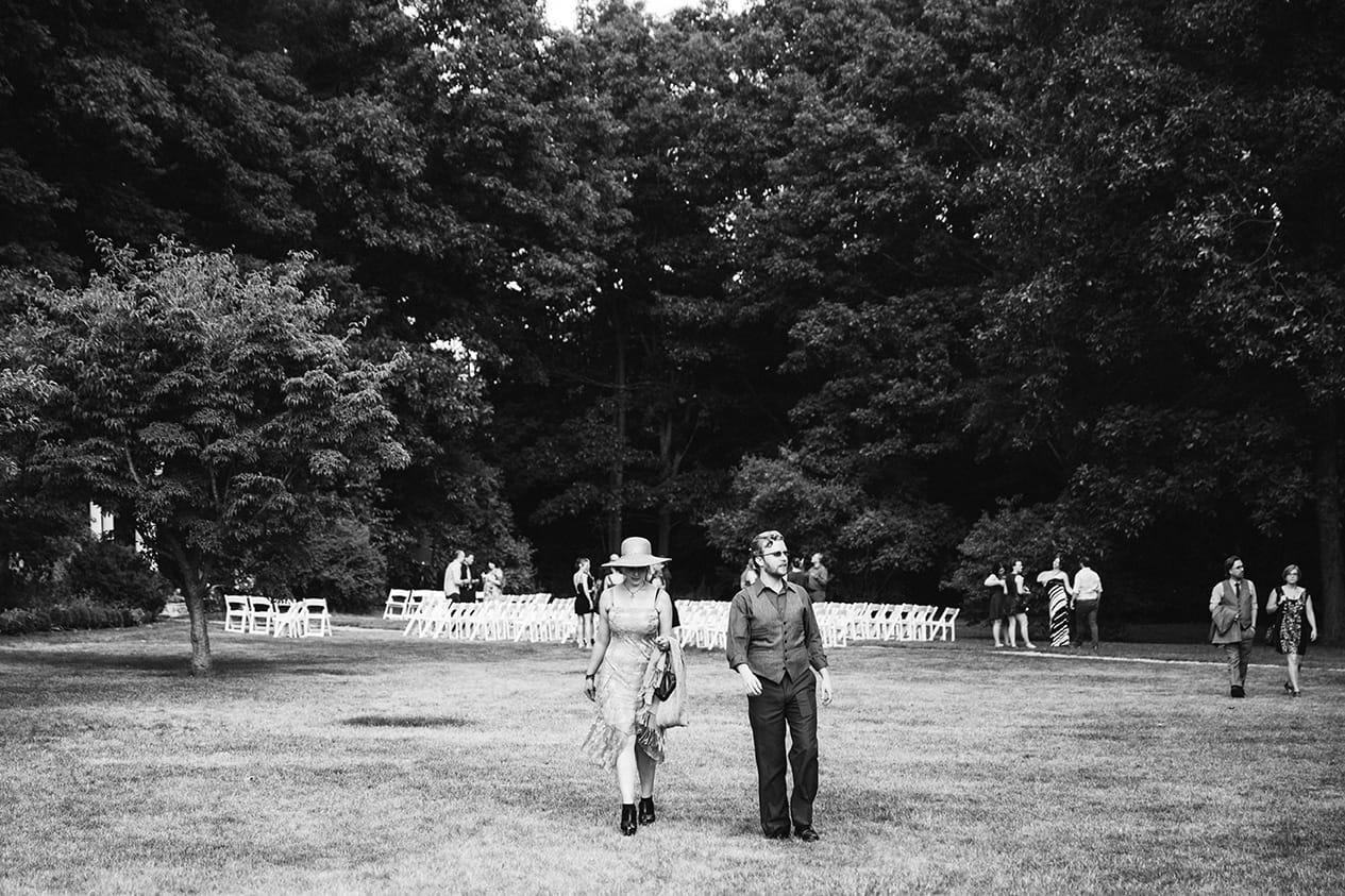 A documentary photograph of a couple walking to the cocktail hour at a Lyman Estate Wedding in Boston, Massachusetts