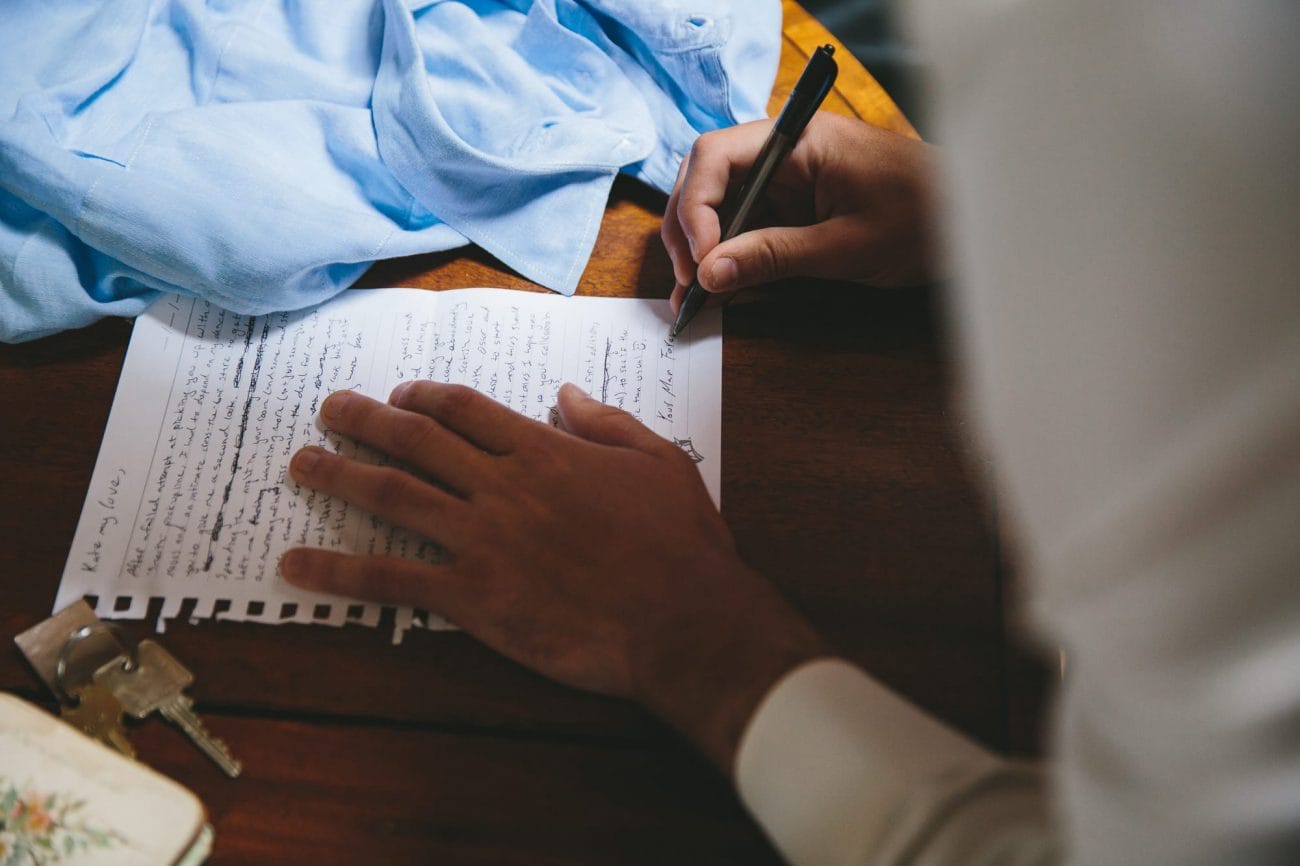 This documentary photograph of a groom writing a letter to his bride is one of the best wedding 