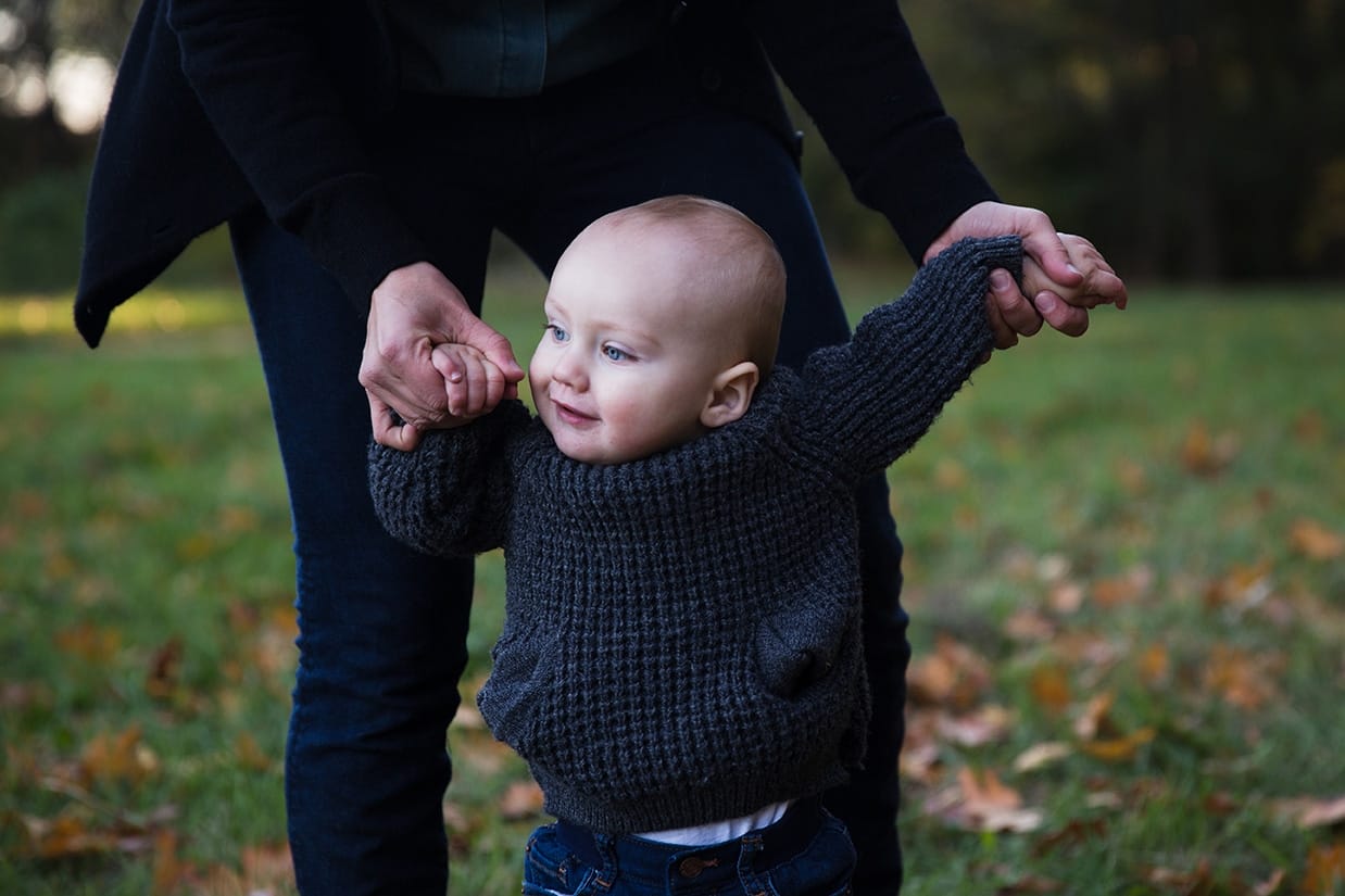 This family photograph of a mom helping her son walk in the arboretum is one of the best family photographs of 2016