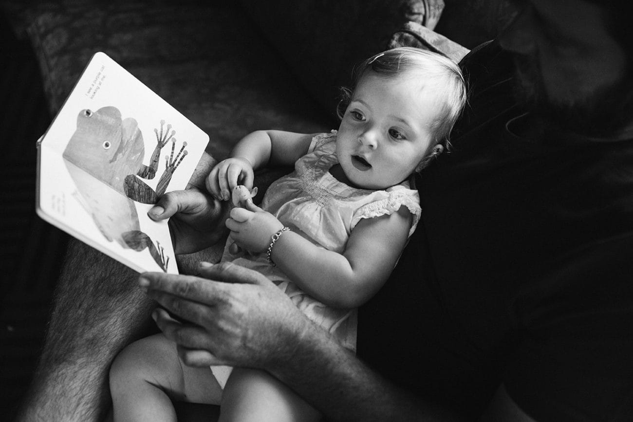This documentary photograph of a father reading a book to his daughter is one of the best family photographs of 2016