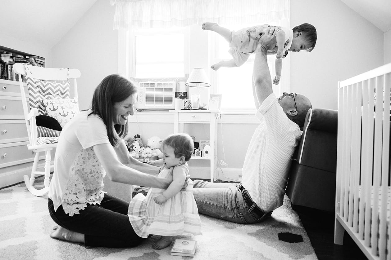 This documentary photograph of a mother and father playing with their twin babies is one of the best family photographs of 2016