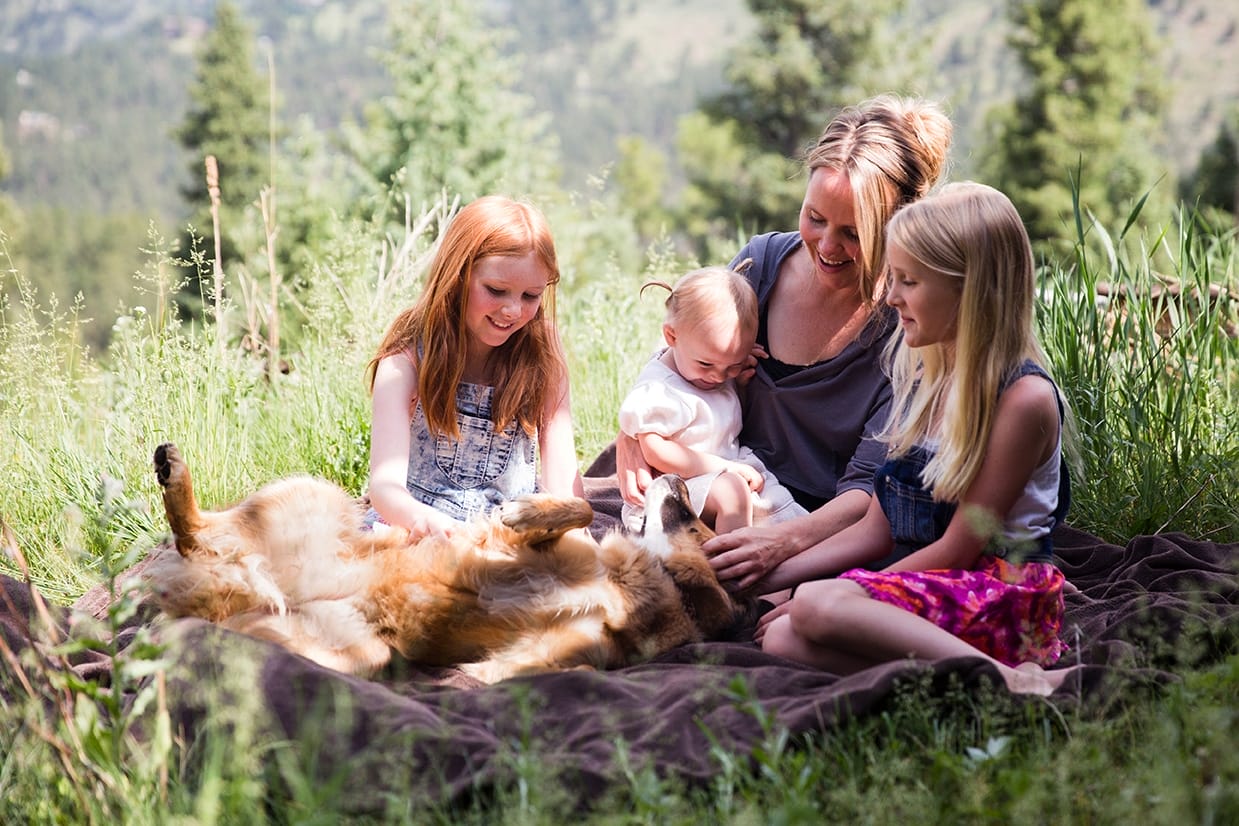 This lifestyle portrait of a family petting their dog is one of the best family photographs of 2016