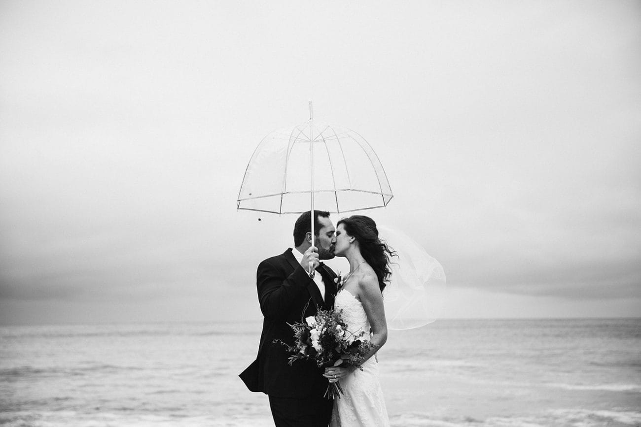 This natural portrait of a bride and groom kissing in the rain is one of the best wedding photographs of 2016