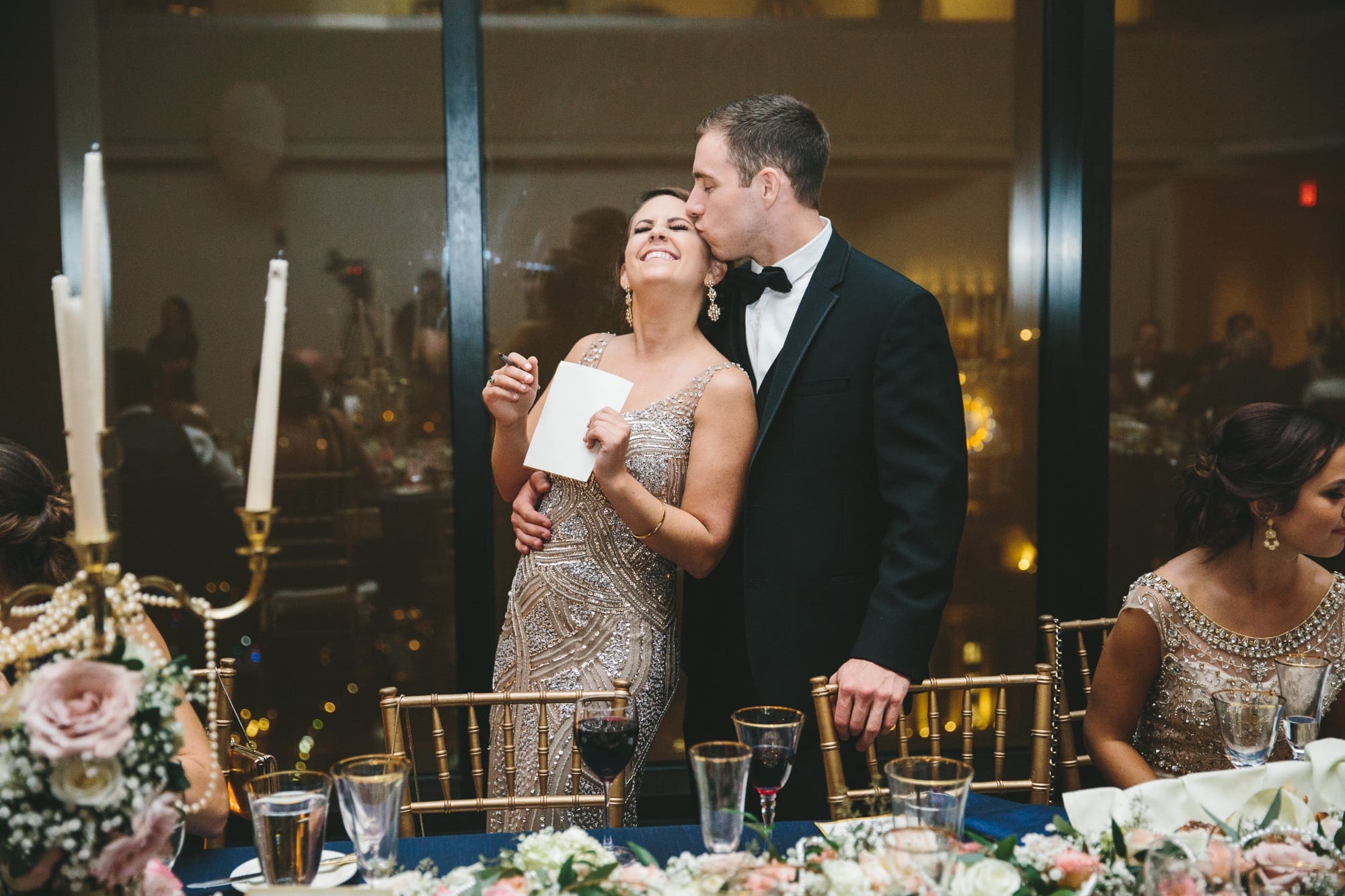 This documentary photograph of a couple kissing at a state room wedding reception is one of the best wedding photographs of 2016