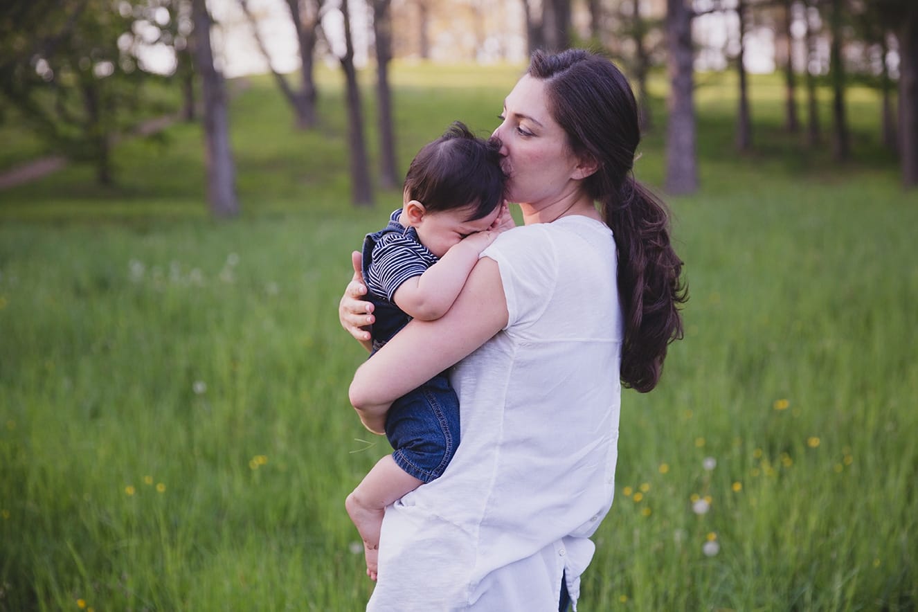 This lifestyle portrait of a mother soothing her son is one of the best family photographs of 2016.