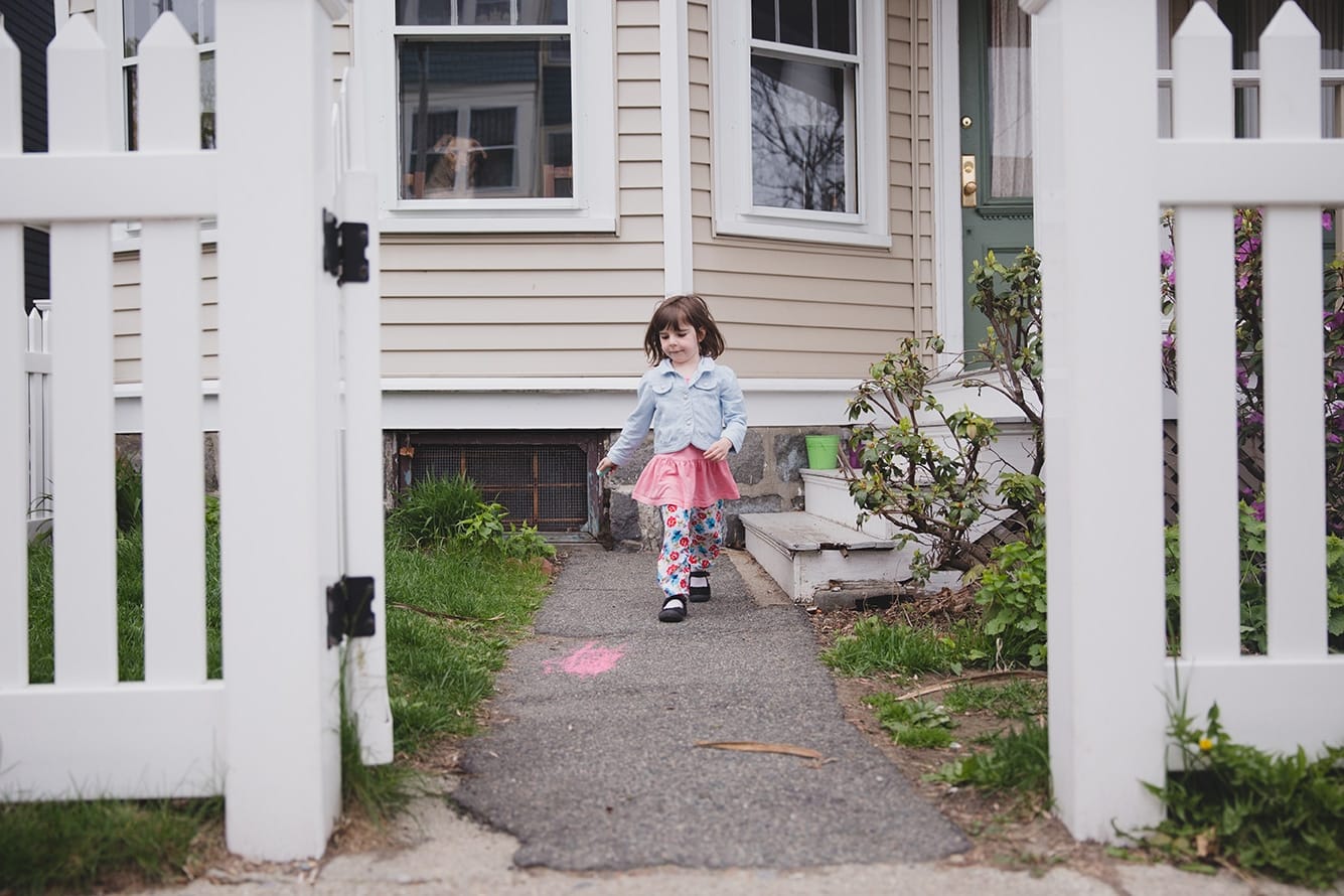 This lifestyle photograph of a little girl running in her front yard is one of the best family photographs of 2016.