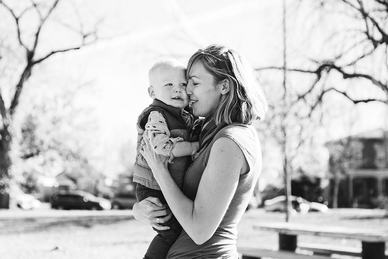 This documentary photograph of a mother kissing her son is one of the best family photographs of 2016