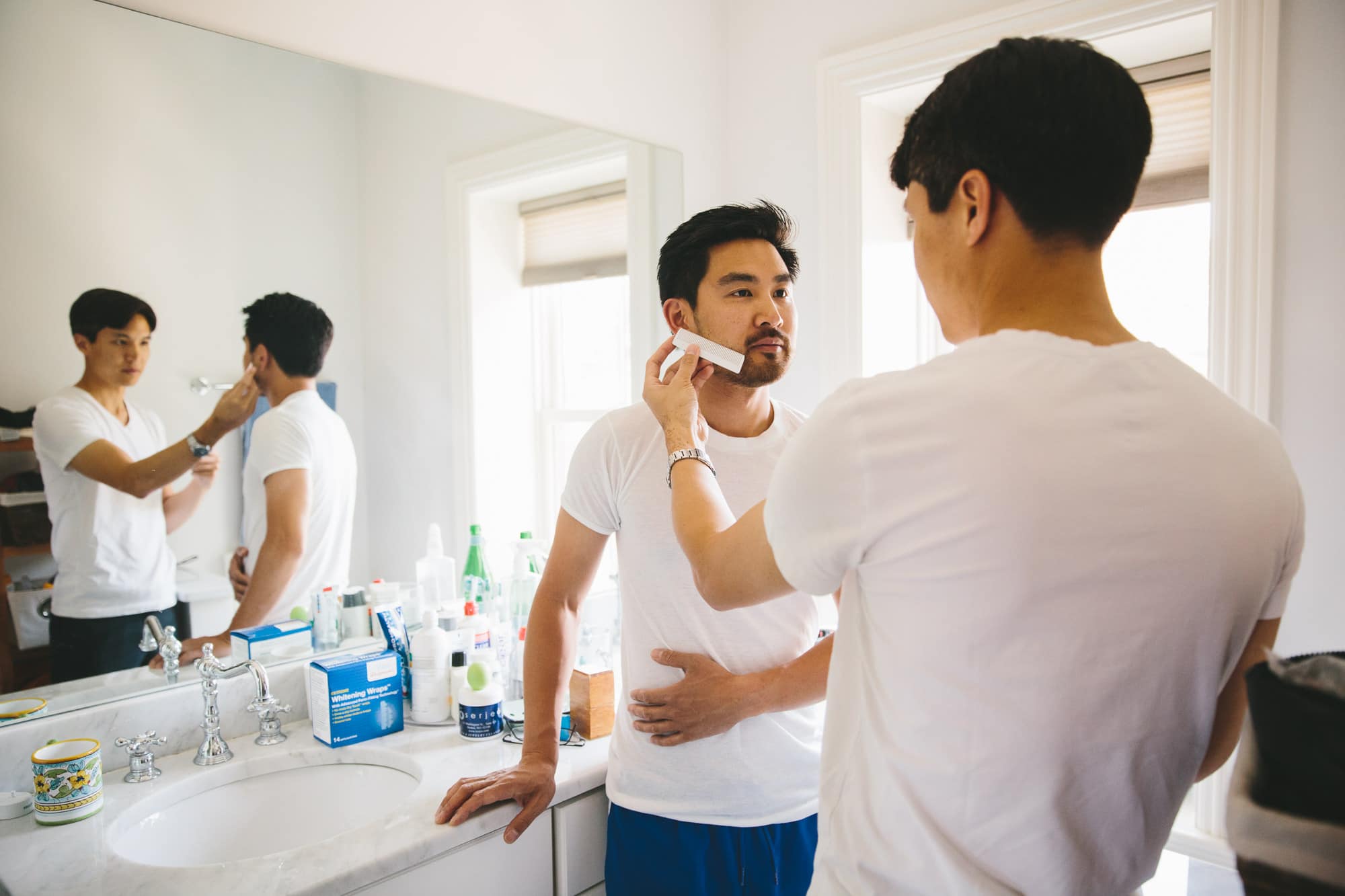 This documentary photograph of a groom getting ready for his artists for humanity wedding is one of the best wedding photographs of 2016