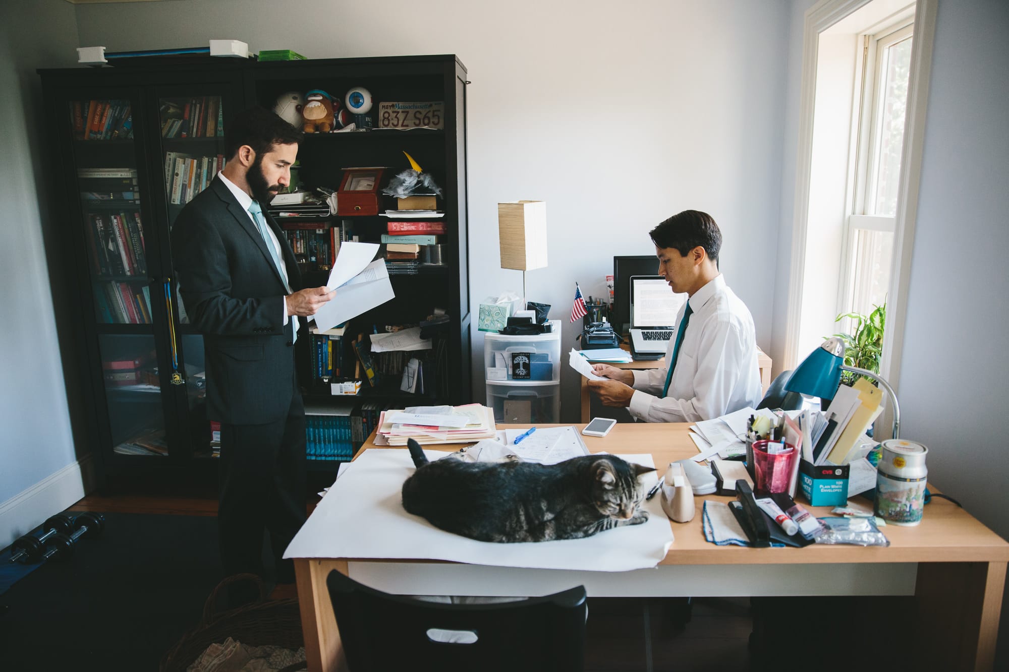 This documentary photograph of groomsmen preparing their speeches before an artists for humanity wedding is one of the best wedding photographs of 2016