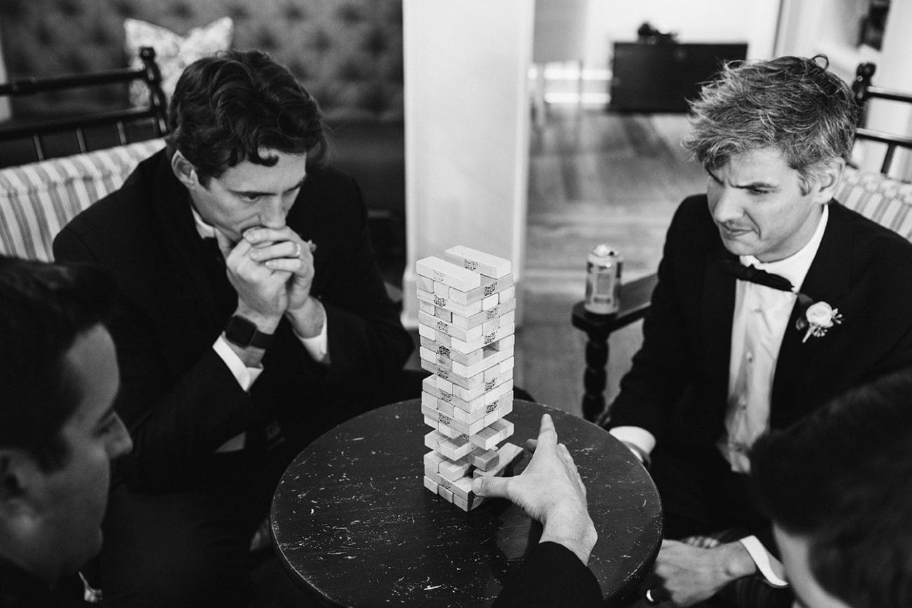 This documentary photograph of groomsmen playing jenga before a nantucket wedding is one of the best wedding photographs of 2016