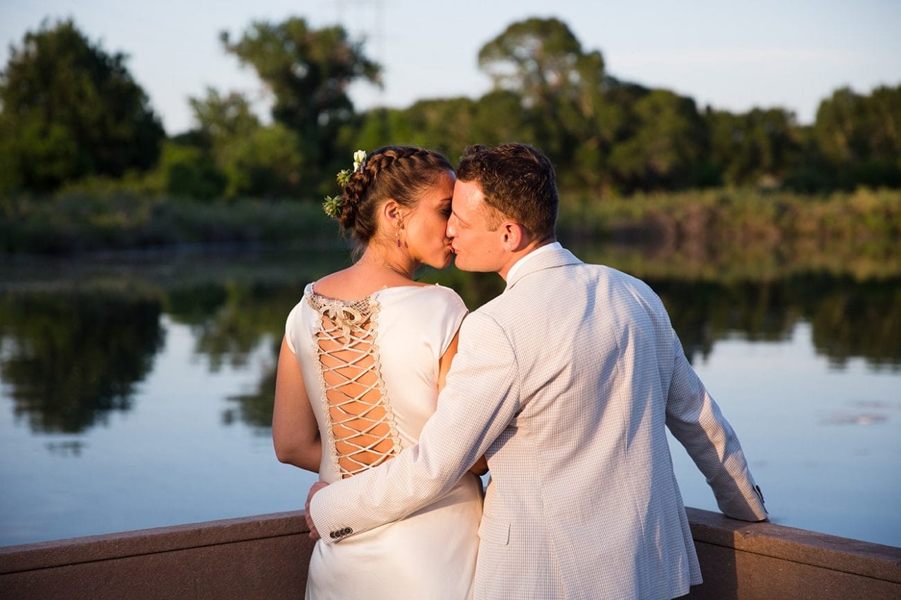 This documentary photograph of a bride and groom kissing at a lake is one of the best wedding photographs of 2016