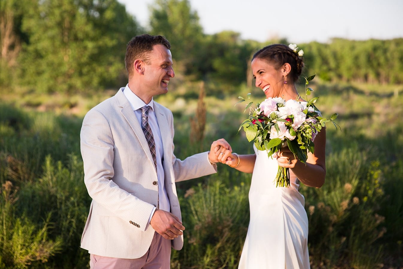 This documentary photograph of a bride and groom laughing together is one of the best wedding photographs of 2016