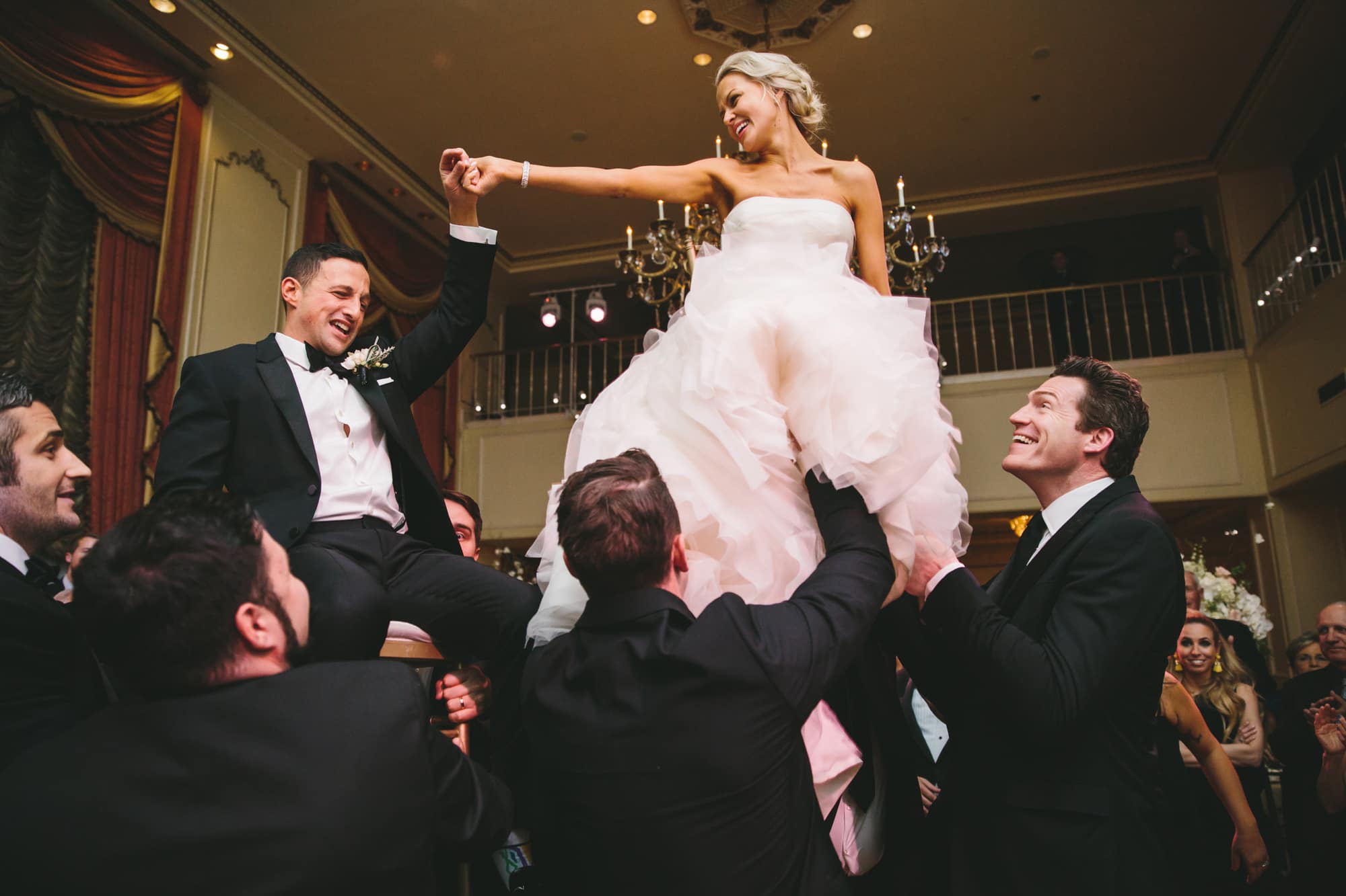 This documentary photograph of a bride and groom during the hora is one of the best wedding photographs of 2016