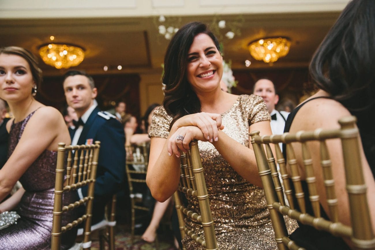 This documentary photograph of a bride smiling during the wedding toasts is one of the best wedding photographs of 2016