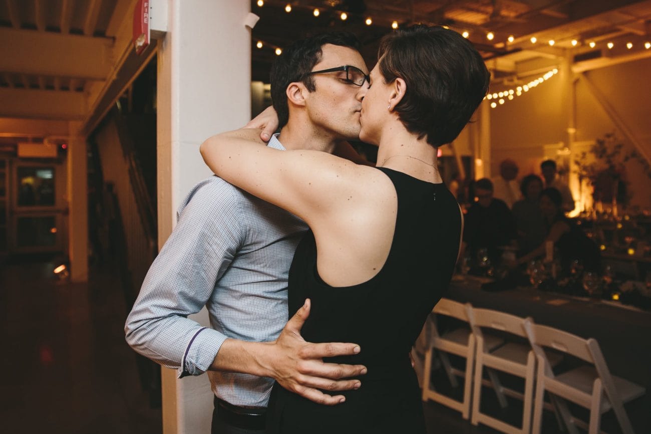 This photojournalistic photograph of a couple kissing at an artists for humanity wedding reception is one of the best wedding photographs of 2016