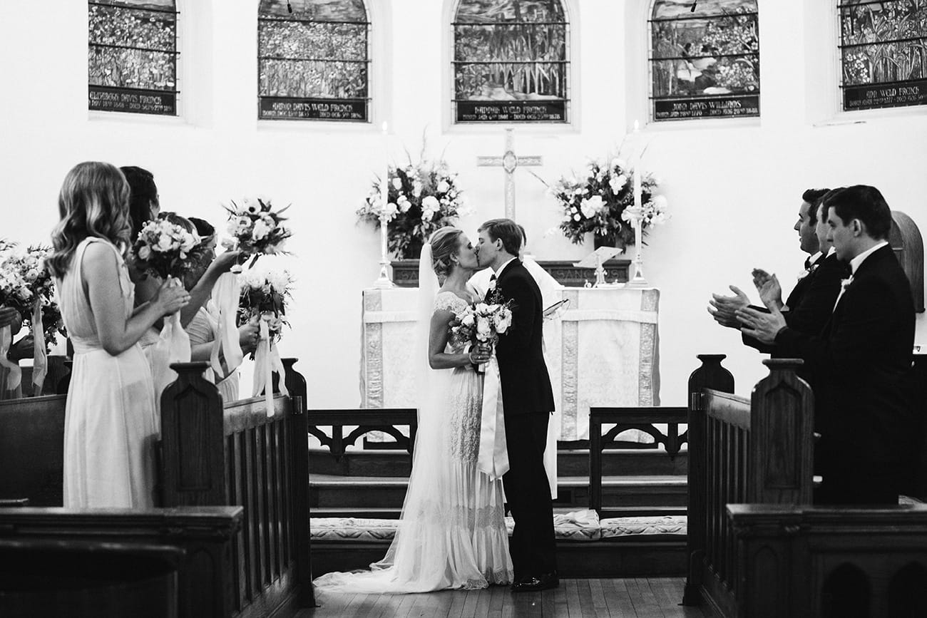 this documentary photograph of a bride and groom kissing at the altar is one of the best wedding photographs of 2016
