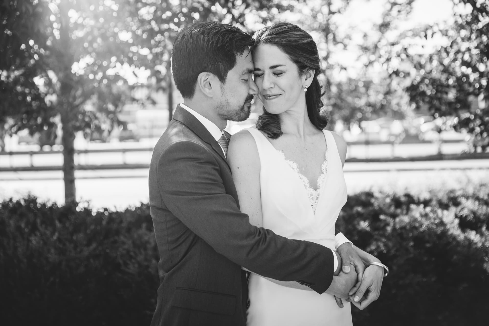 A natural portrait of a groom hugging his bride before their Artists for Humanity Wedding in Boston, Massachusetts