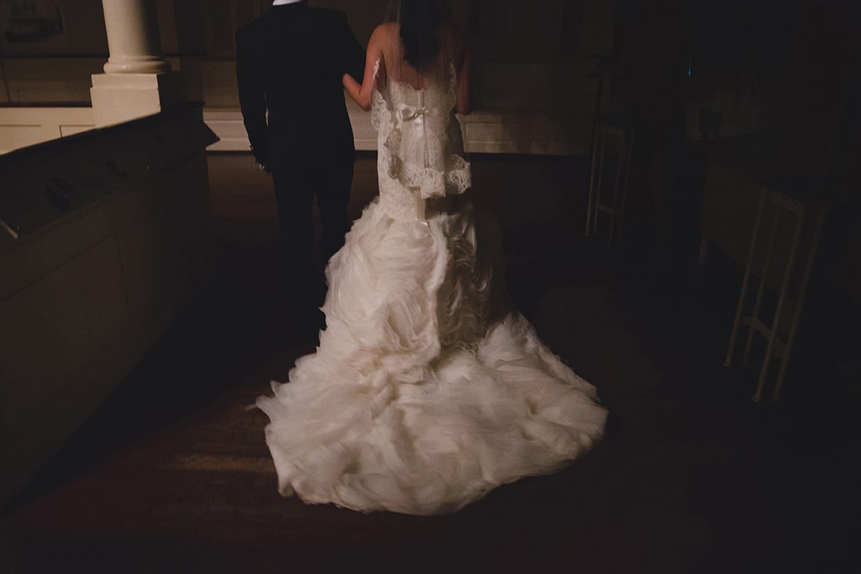 A documentary photograph of a bride an groom walking away together after becoming husband and wife during their old south meeting house and marliave wedding in Boston, Massachusetts