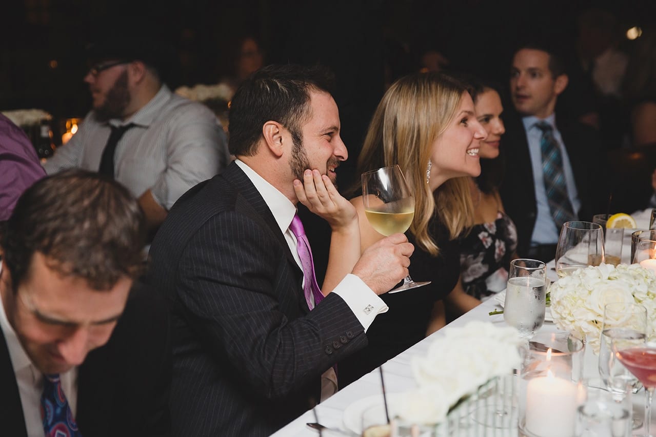 A documentary photograph of guest talking and laughing during a Marliave wedding reception in Boston, Massachusetts
