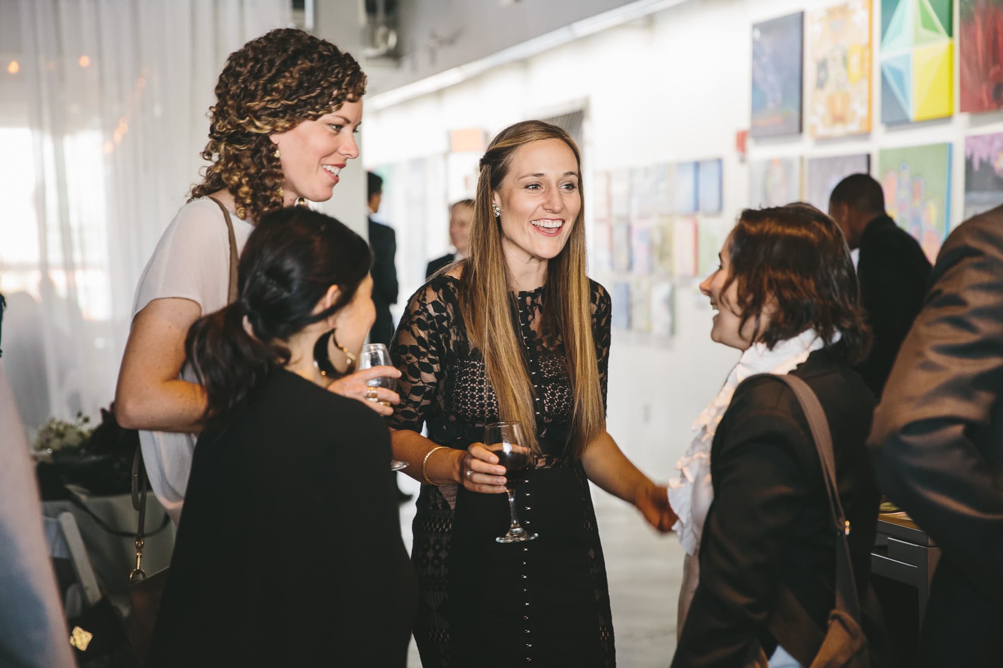 A documentary photograph of a guests talking during an Artists for Humanity Wedding in Boston