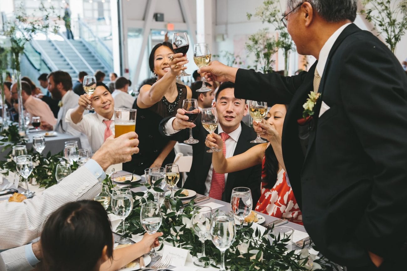 A documentary photograph of guests toasting the couple during an Artists for Humanity Wedding in Boston