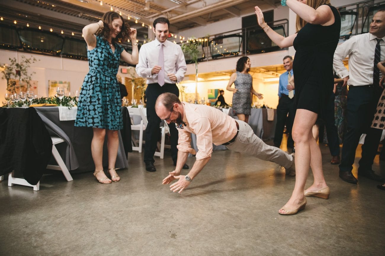 A documentary photograph of guests dancing during an Artists for Humanity Wedding in Boston, Massachusetts