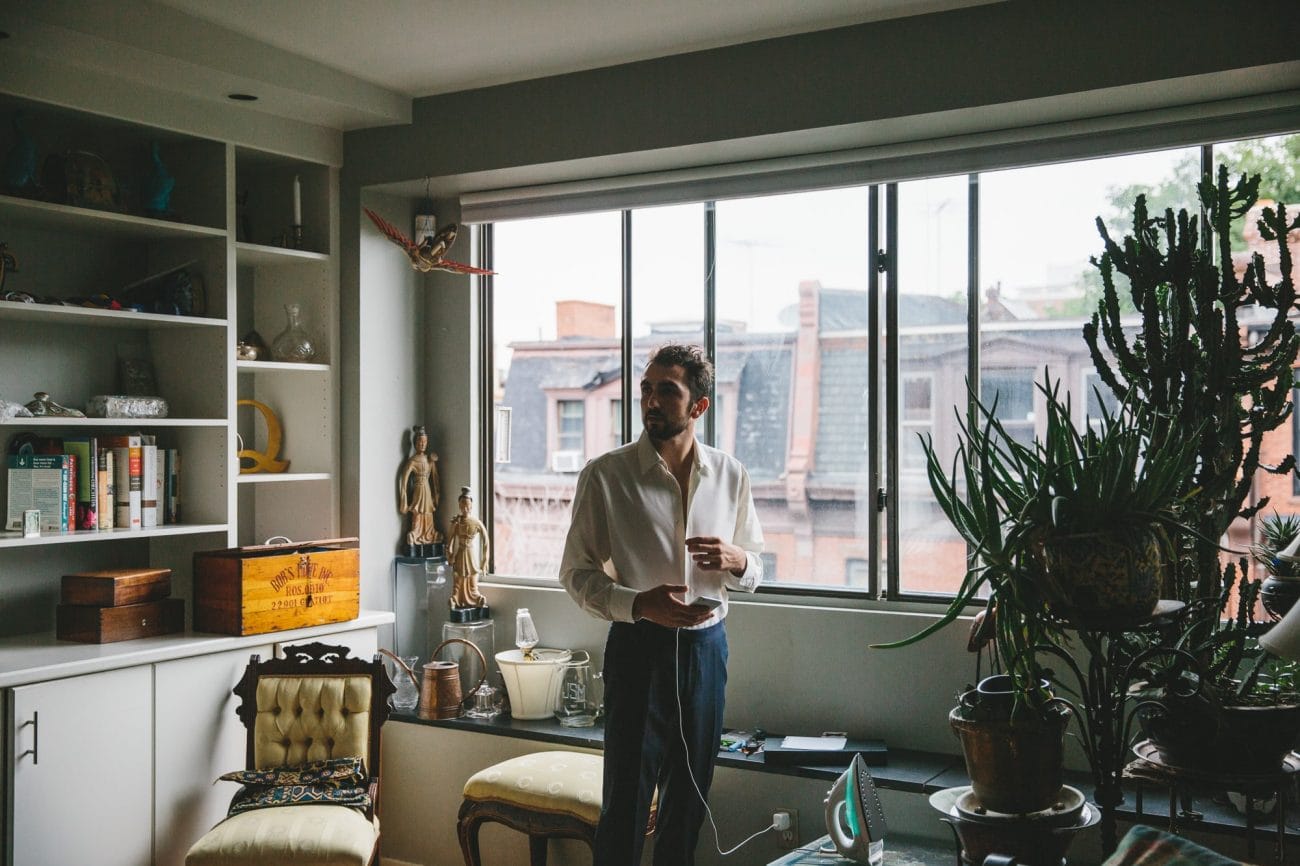 A documentary photograph of a groom getting ready for his State Room Wedding in Boston, Massachusetts
