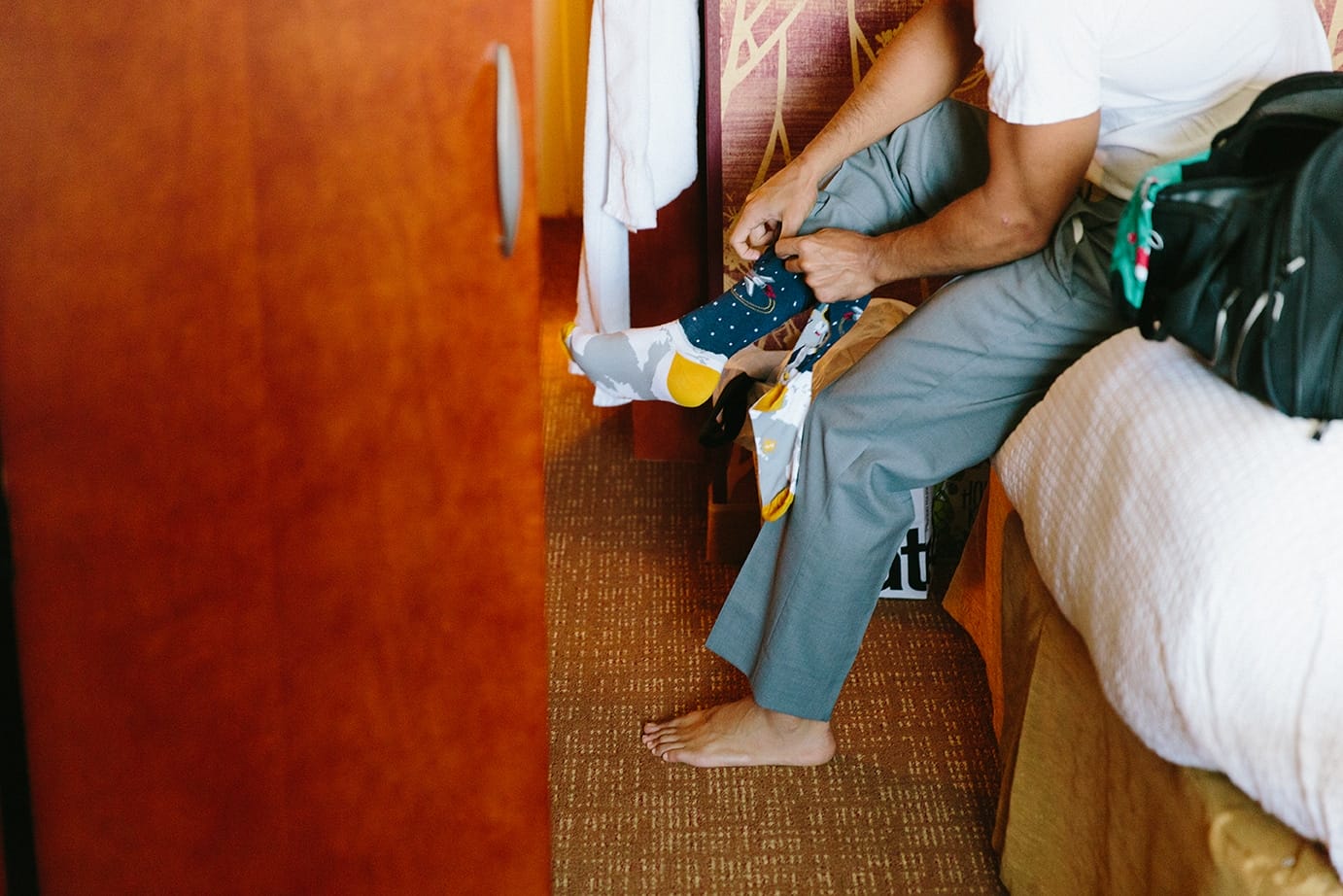 A documentary photograph of groomsmen getting ready for a moraine farm wedding in Beverly, Massachusetts
