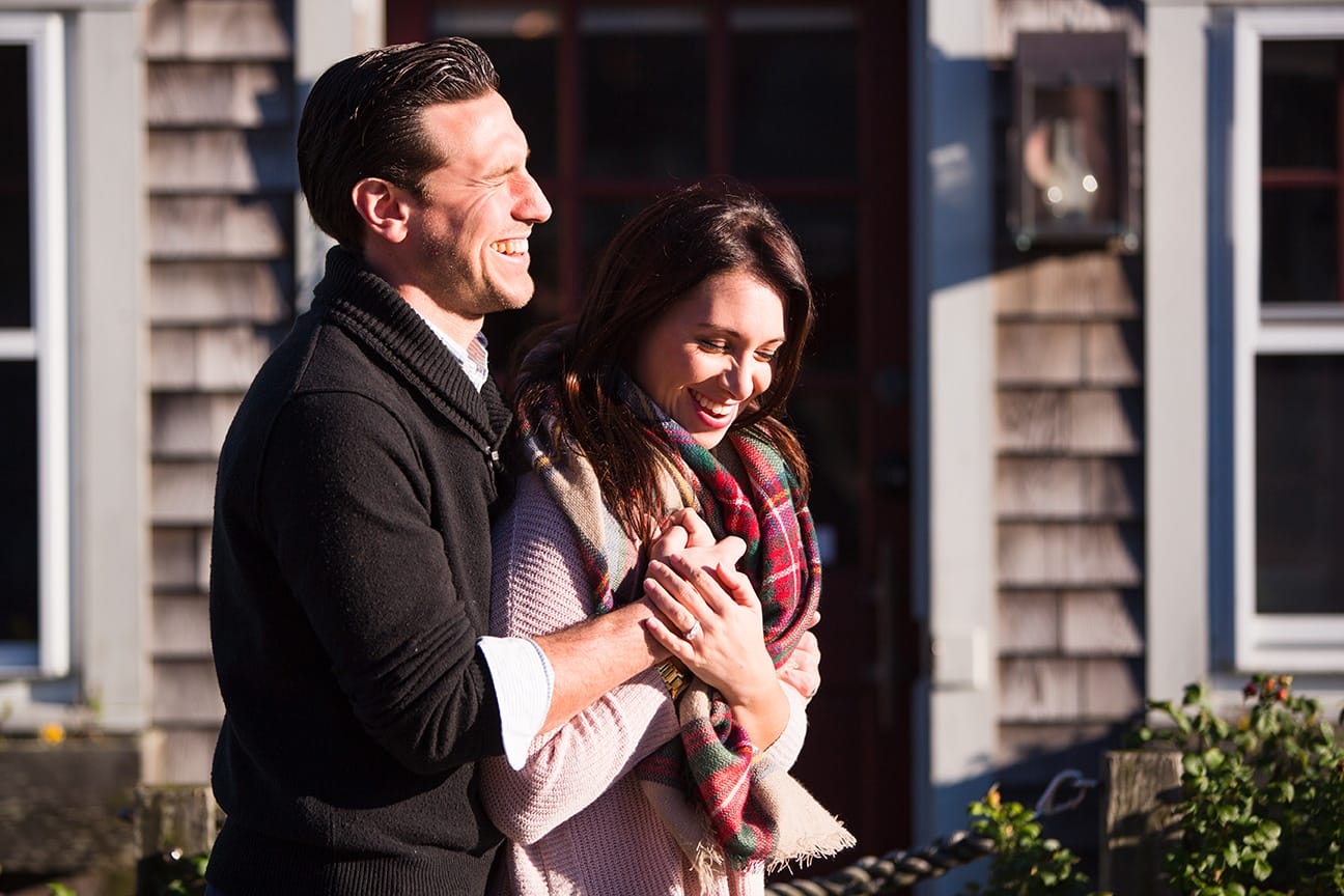 A documentary photograph of a couple laughing during their honey moon photo session on Martha's Vineyard